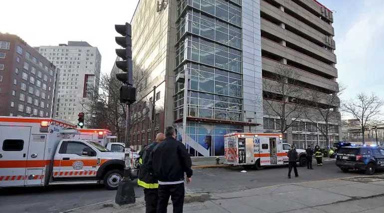 A woman and two kids dead near a parking garage in Boston. Photo AP.